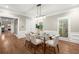 Formal dining room with modern light fixture, neutral walls and floor to ceiling windows at 194 Sentinel Se Pl, Marietta, GA 30067