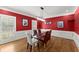 Dining room showcases bold red walls, white trim, and a modern glass table at 194 Sentinel Se Pl, Marietta, GA 30067