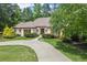 Well-manicured lawn and circular driveway leading up to a stately home at 194 Sentinel Se Pl, Marietta, GA 30067