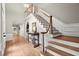 Spacious foyer with staircase, hardwood floors, and a decorative table displaying elegant decor at 194 Sentinel Se Pl, Marietta, GA 30067