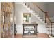 Inviting foyer featuring leaded glass door, hardwood floors, stairs, and decorative table and staircase at 194 Sentinel Se Pl, Marietta, GA 30067