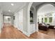 Hallway showcasing hardwood floors, white trim, arched doorway, and open access to the living room at 194 Sentinel Se Pl, Marietta, GA 30067