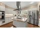 Bright kitchen features white cabinets, stainless steel appliances, and a granite-topped island at 194 Sentinel Se Pl, Marietta, GA 30067