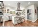 Bright eat-in kitchen with granite countertops, stainless appliances, central island with seating and open view to laundry area at 194 Sentinel Se Pl, Marietta, GA 30067