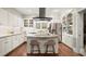 Modern kitchen featuring granite counters, an island with seating, stainless steel appliances, and hardwood floors at 194 Sentinel Se Pl, Marietta, GA 30067