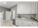 Practical laundry area featuring a sink, counter space, and storage cabinets for efficient household chores at 194 Sentinel Se Pl, Marietta, GA 30067