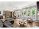 Bright living room boasts wall of windows overlooking pool, fireplace, and open layout at 194 Sentinel Se Pl, Marietta, GA 30067