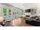 Bright living room boasts wall of windows overlooking pool, fireplace, and open space at 194 Sentinel Se Pl, Marietta, GA 30067
