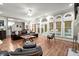 Sunlit living room featuring hardwood floors, arched windows, and access to the outdoor pool area at 194 Sentinel Se Pl, Marietta, GA 30067