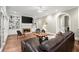 Comfortable living room with hardwood floors, fireplace, built-in shelving, and large windows at 194 Sentinel Se Pl, Marietta, GA 30067