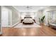 Bright main bedroom features a ceiling fan, hardwood floors, neutral paint, and a seating area at 194 Sentinel Se Pl, Marietta, GA 30067