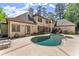 A luxury home's backyard features a beautiful pool with an attached spa, patio, and manicured landscaping at 194 Sentinel Se Pl, Marietta, GA 30067