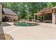 An in-ground pool is steps away from an outdoor kitchen, dining area, and seating, perfect for backyard entertaining at 194 Sentinel Se Pl, Marietta, GA 30067