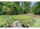 Practice your short game on this backyard putting green surrounded by mature trees at 194 Sentinel Se Pl, Marietta, GA 30067