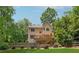 View of the two-story home's backyard with a wooden deck and surrounding trees and a soccer net on manicured lawn at 2622 Murdock Rd, Marietta, GA 30062