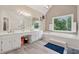 This bathroom features double sinks, white cabinets, and a separate soaking tub at 2622 Murdock Rd, Marietta, GA 30062