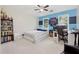 This bedroom features blue accent walls, a ceiling fan, and a large bookshelf at 2622 Murdock Rd, Marietta, GA 30062