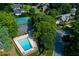 Overhead view of a community pool, tennis court, and landscaped yards with lush green trees at 2622 Murdock Rd, Marietta, GA 30062