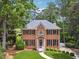Attractive two-story brick home with manicured lawn and mature trees creating a serene setting at 2622 Murdock Rd, Marietta, GA 30062