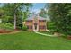 Beautiful brick home with lush green lawn, mature trees, and well-maintained landscaping at 2622 Murdock Rd, Marietta, GA 30062
