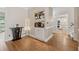 Elegant hallway with hardwood floors, built-in bar, and view into kitchen at 2622 Murdock Rd, Marietta, GA 30062