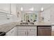 Kitchen island featuring granite countertops, stainless steel sink, and a view of the breakfast nook at 2622 Murdock Rd, Marietta, GA 30062