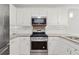 Close-up of the kitchen featuring stainless steel appliances, granite countertops, and white subway tile backsplash at 2622 Murdock Rd, Marietta, GA 30062