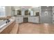 Elegant bathroom featuring a soaking tub, and sinks, and tiled floors at 4519 Mossey Dr, Lithonia, GA 30038
