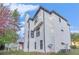 Multi-story exterior elevation highlighting white painted brick, dark trim, and surrounding landscaping at 4519 Mossey Dr, Lithonia, GA 30038