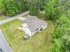 Aerial view of the house with a greenhouse and well-maintained yard surrounded by trees at 5008 Monticello Dr, Villa Rica, GA 30180