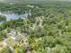 Aerial view of houses among dense greenery near a lake at 5008 Monticello Dr, Villa Rica, GA 30180