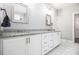 Stylish bathroom with double vanity, granite countertop, white cabinets, and marble floors at 5008 Monticello Dr, Villa Rica, GA 30180
