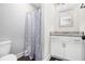A bathroom featuring a granite countertop, white cabinetry, and a modern shower curtain for a sleek design at 5008 Monticello Dr, Villa Rica, GA 30180