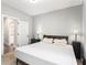 Bright bedroom features a large bed, two side tables with lamps, and an open doorway to another room at 5008 Monticello Dr, Villa Rica, GA 30180