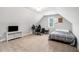Spacious bonus room with a bed, TV, and office setup under the angled ceilings at 5008 Monticello Dr, Villa Rica, GA 30180