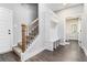 Entryway featuring wood-look floors, stairs, a hall tree, and a view into another room at 5008 Monticello Dr, Villa Rica, GA 30180