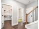 Hallway with wood-look floors leads to a pantry and a room with a green rug at 5008 Monticello Dr, Villa Rica, GA 30180