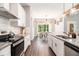 Modern kitchen featuring white cabinets, stainless steel appliances, and an adjacent dining area at 5008 Monticello Dr, Villa Rica, GA 30180