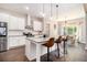 Modern kitchen featuring an island with barstool seating, white cabinets, and stainless steel appliances at 5008 Monticello Dr, Villa Rica, GA 30180