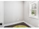 Small, empty room with dark wood floors, a green rug, and natural light at 5008 Monticello Dr, Villa Rica, GA 30180