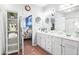 Bathroom with dual sinks, linen storage, and access to the bedroom at 989 Brownstone Ln # 16, Marietta, GA 30008