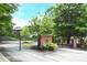 Gated community entrance with decorative brickwork and well-manicured landscaping at 989 Brownstone Ln # 16, Marietta, GA 30008