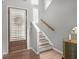 A foyer featuring a stylish front door, stairs, hardwood floors, and neutral wall colors at 989 Brownstone Ln # 16, Marietta, GA 30008