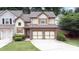 Charming home with a well-manicured lawn, a two-car garage, and beautiful exterior detailing at 989 Brownstone Ln # 16, Marietta, GA 30008