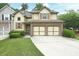 Charming two-story home featuring a two-car garage, brick accents, and well-maintained lawn at 989 Brownstone Ln # 16, Marietta, GA 30008