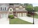 Two-story home featuring a two-car garage, brick accents, shuttered windows, and well-maintained lawn at 989 Brownstone Ln # 16, Marietta, GA 30008