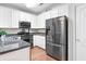 Bright kitchen featuring white cabinets, stainless steel appliances, and modern fixtures at 989 Brownstone Ln # 16, Marietta, GA 30008