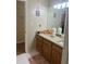 Bathroom vanity featuring ample counter space with wood cabinets and a decorative mirror at 1311 N Brandy Se Shls, Conyers, GA 30013