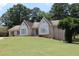 Beautiful single-story brick home with large windows and a well-maintained front lawn at 1311 N Brandy Se Shls, Conyers, GA 30013
