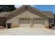 Two car garage of a brick home with white doors at 1311 N Brandy Se Shls, Conyers, GA 30013